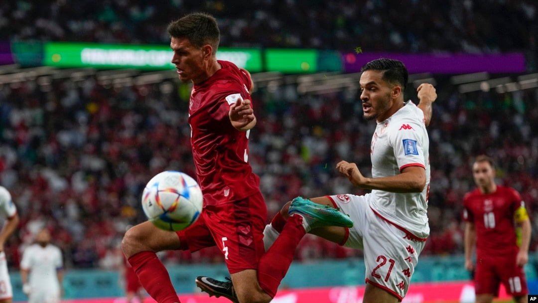 Tunisia and Denmark players contest the ball at the 2022 FIFA World Cup. Photo: VOA.