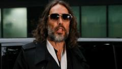 Woman describes alleged assault by Russell Brand as 'frenzied' and 'violent'