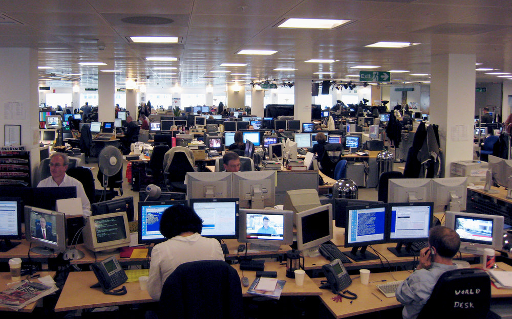 Reuters Institute newsroom with journalists monitoring developing stories. Illustrative newsroom photo.